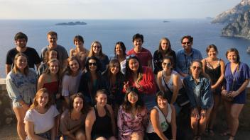 Group photo of students with a backdrop of a body of water