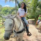 photo of a student sitting on a horse during her internship abroad