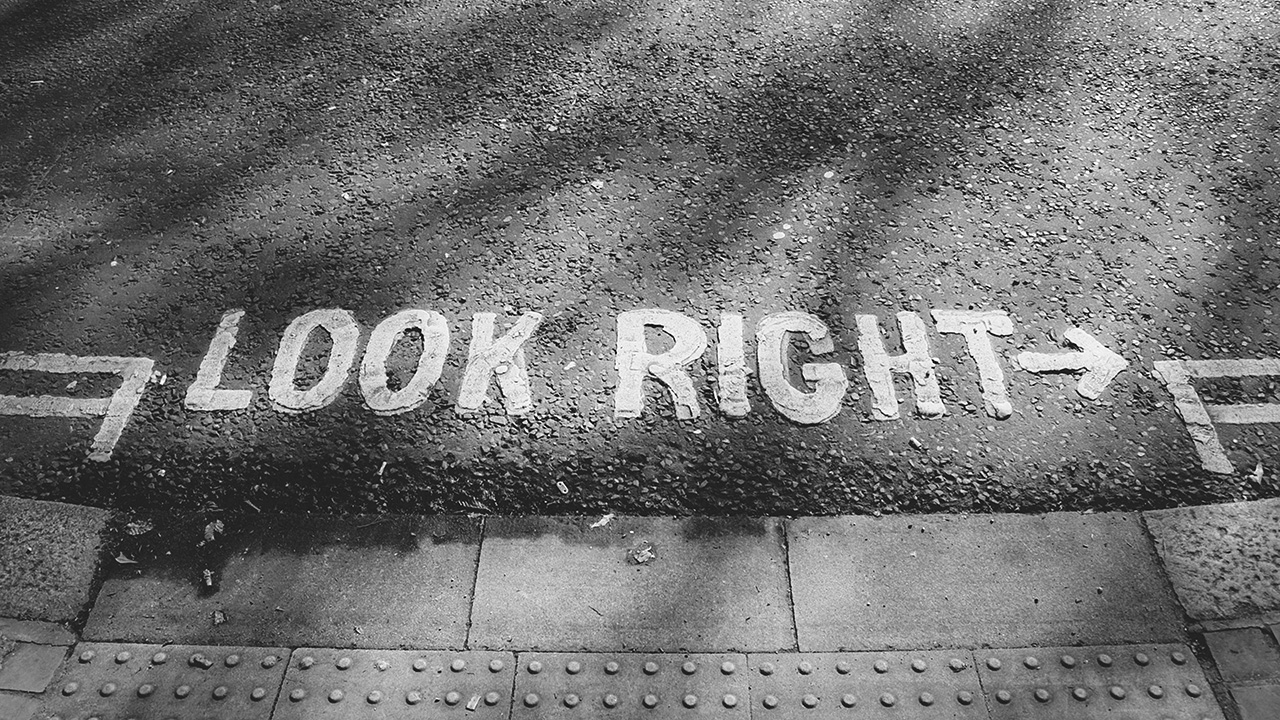 Image of a street with text on the ground that reads 'Look Right'
