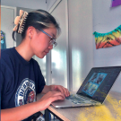 Photo of a student in front of her computer participating in global internship
