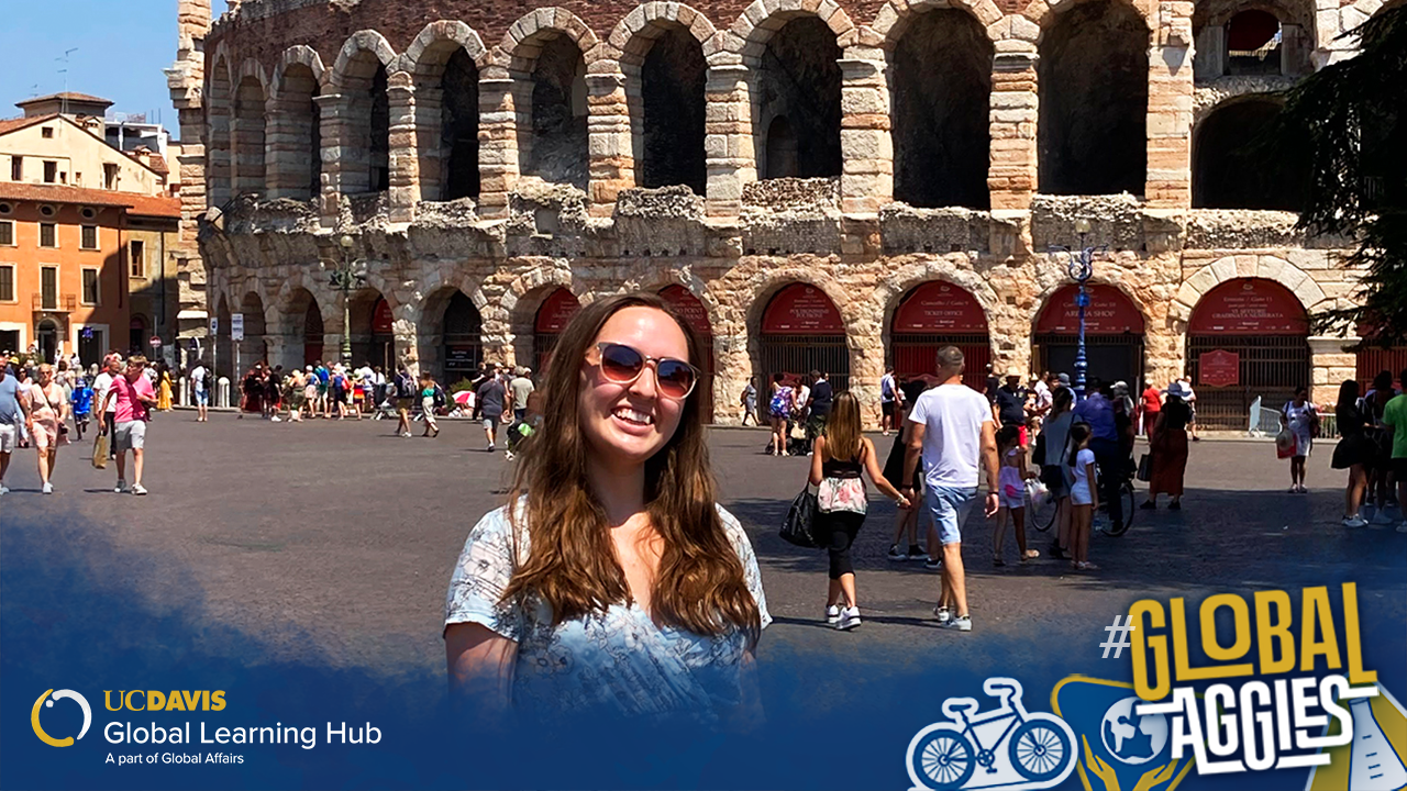Photo of a student standing in front of the Verona Arena in Verona, Italy.