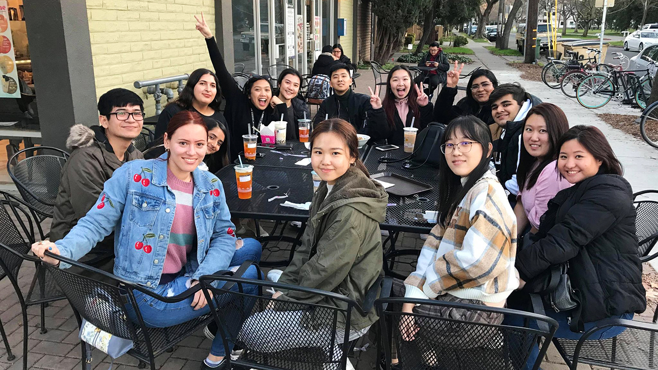 Student dining outside a restaurant in downtown Davis.