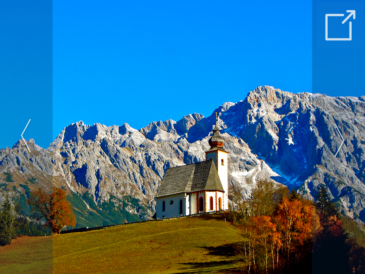 Photo of a church on a hill, with blue skies in the background