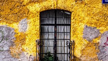 image of a window with yellow wall surrounding it