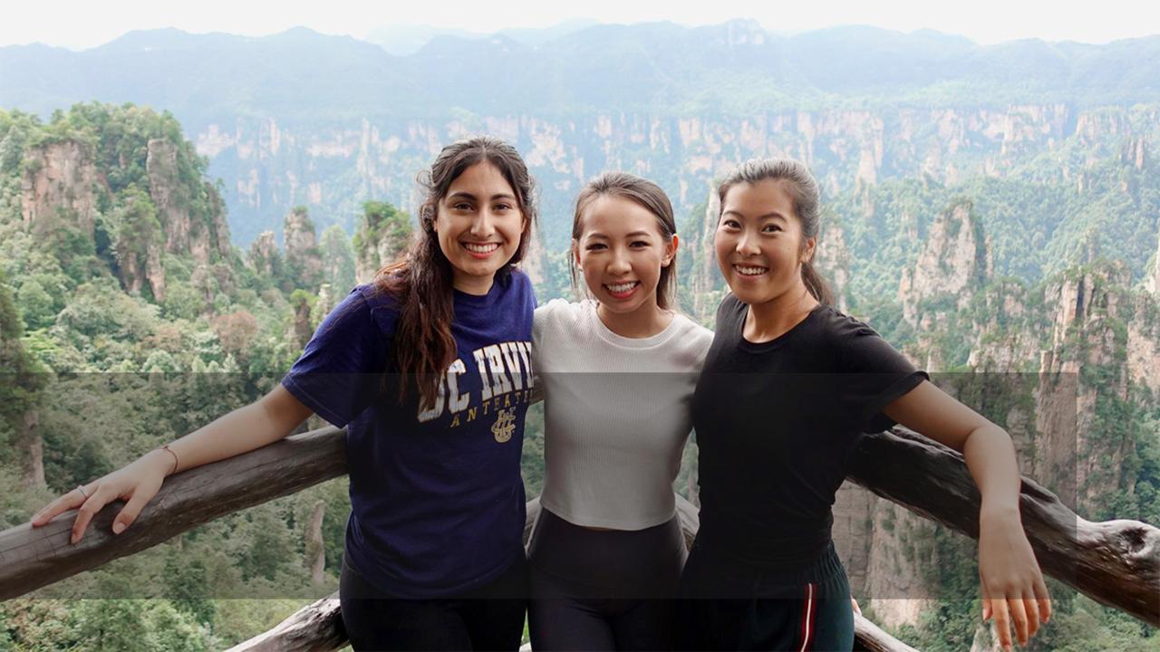 Image of three students looking into the camera and smiling