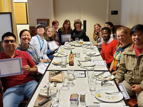 people sitting around a table having lunch