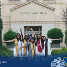 Group photo of students standing in front of the George Hart Hall building on the UC Davis campus.
