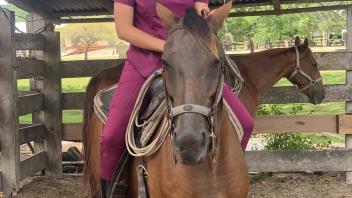 student riding a horse
