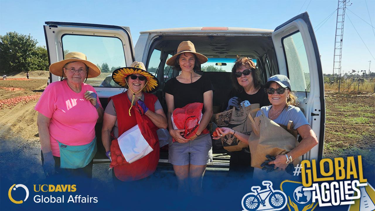 Five people pose with bags of produce in front of a white van in a rural setting. UC Davis Global Affairs and "#GlobalAggies" are displayed in the foreground.