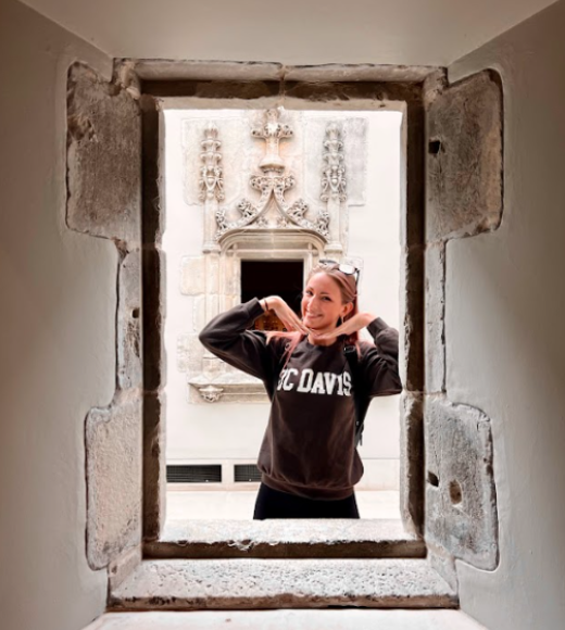 Jessica in Scotland taking a picture in a hole in the wall.