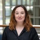 Brooke smiles in a black shirt in the International Center.