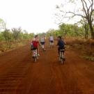 Teaser image of students on a bike riding down a dirt road - Click to learn more about this program
