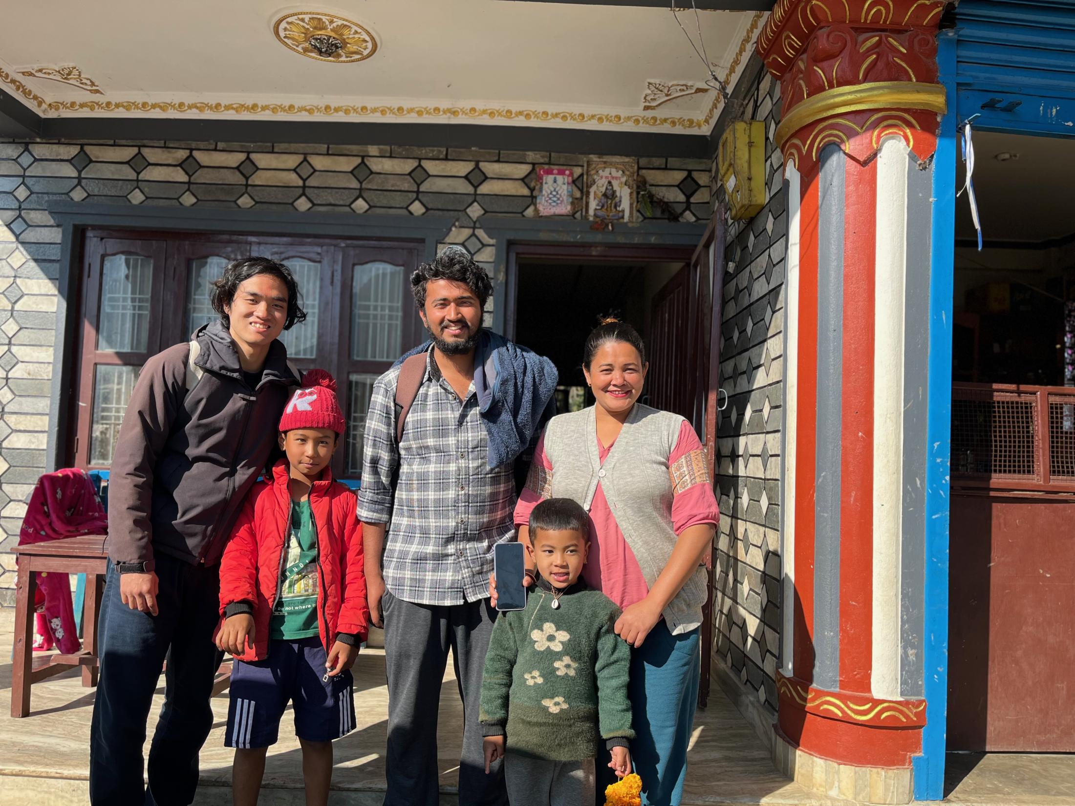 Hatano smiles next to his host family and Nepali friend in Machhapuchhre Village.