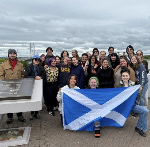 UC Davis student Anya Nygaard and her cohort as they hold up the national flag of Scotland.