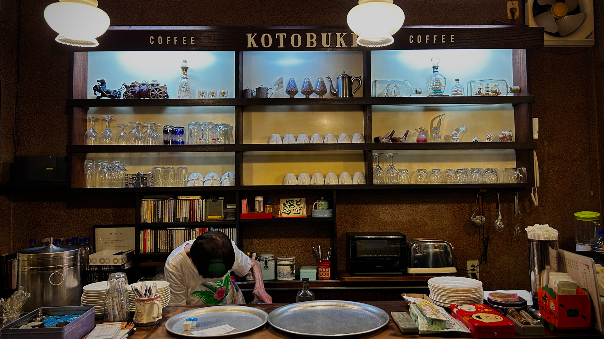 A person skillfully preparing ingredients in a well-equipped kitchen, surrounded by various cooking tools and fresh produce.