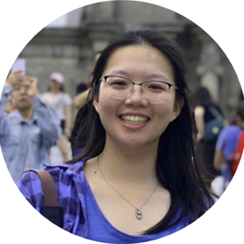Student smiling, standing in front of other students