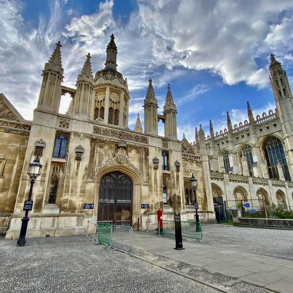 Gothic-style building with ornate spires and arched windows under a cloudy sky.