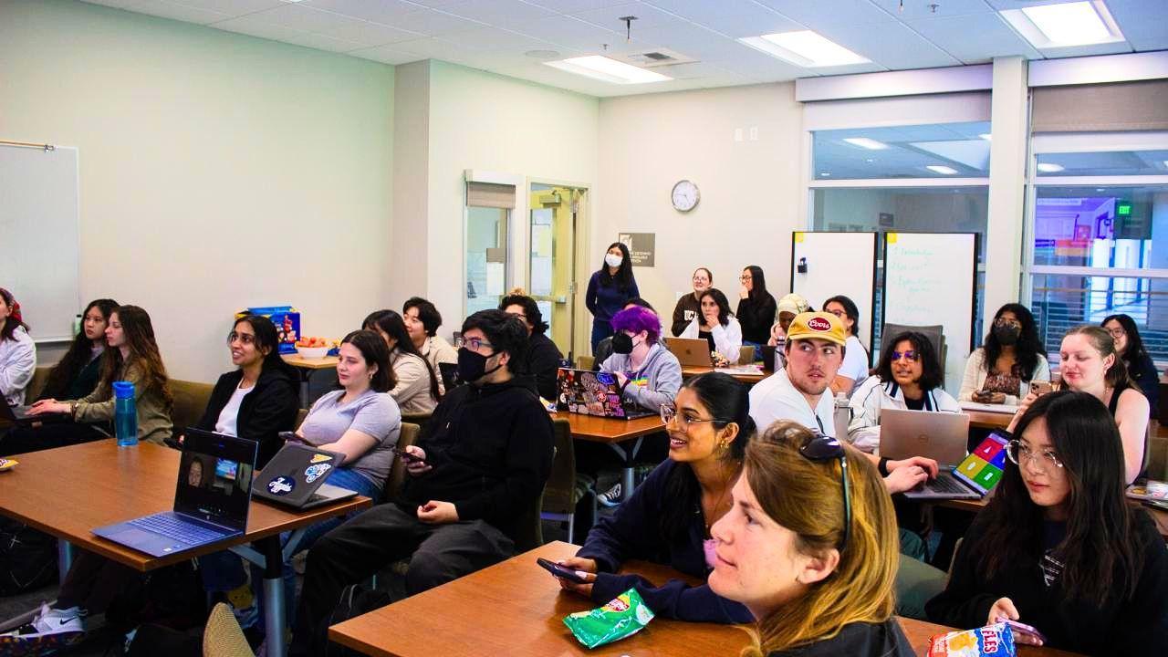 Students attentively seated at desks in bright classroom during a lecture